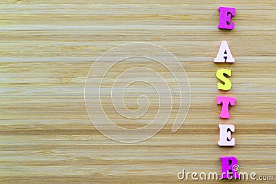 Letters lie on wooden background. Horiontal inscription Easter Stock Photo