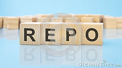 letters REPO made with wood building blocks. blue background. business concept Stock Photo