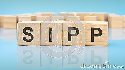 letters sipp made with wood building blocks. blue background. business concept Stock Photo