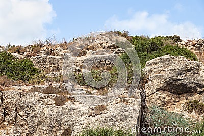 The letters A and T in the old Phoenician language are carved on the stone wall of the old Phoenician fortress, which later Stock Photo