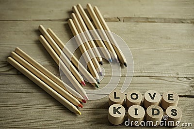 Letters word Love Kids, colorful crayons, pencils Stock Photo