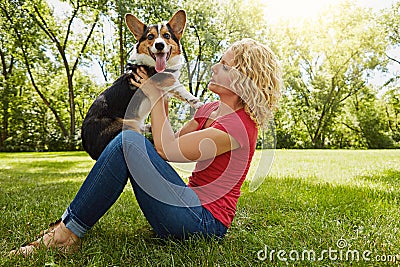 Letting her dog know just how much she loves him. a young woman bonding with her dog in the park. Stock Photo