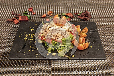lettuce salad, roasted red piquillo peppers with onion and split cherry tomatoes with preserved tuna belly Stock Photo