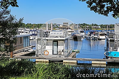 Pier at dutch inland lake harbor marina with houseboats for rent on water Editorial Stock Photo