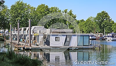 Pier at dutch inland lake harbor marina with houseboats for rent on water Editorial Stock Photo
