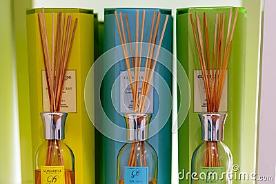 Different coloured perfume air wicks on display in a store in their packaging Editorial Stock Photo