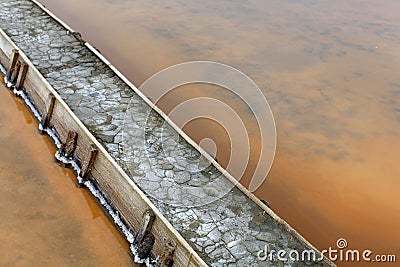 Levee at the salt flats pools filled with brine Stock Photo