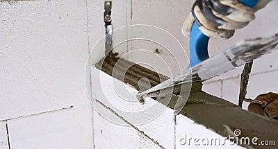 Levelling a mortar with a trowel Stock Photo