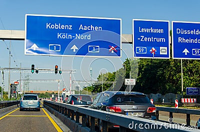 Leverkusen, Germany - July 26, 2019: Road traffic on the German Highway autobahn A1 with road signs and traffic light. Cars ride Editorial Stock Photo