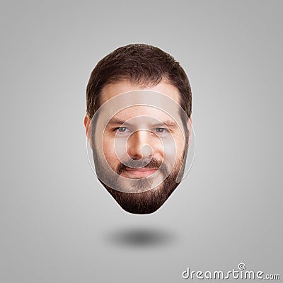 Levitating head of a bearded smiling man isolated on grey background. Creativity, cleverness and intelligence concept Stock Photo