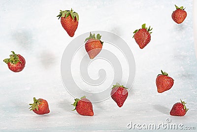 Levitation effect, falling strawberries on light background Stock Photo