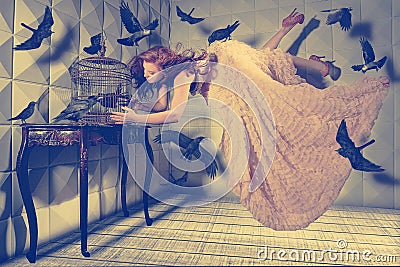 Levitation shot of a Woman and Her Black Birds Stock Photo
