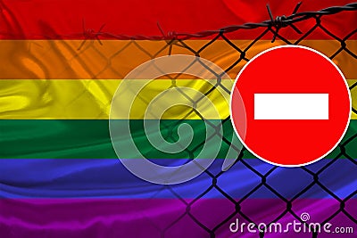 LGBT rainbow flag on satin, fence with barbed wire, symbolic red sign no entry, Freedom problems, concept human rights movement, Stock Photo