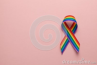 LGBT rainbow ribbon pride tape symbol. Stop homophobia. Pink background. Copy space for text. Stock Photo
