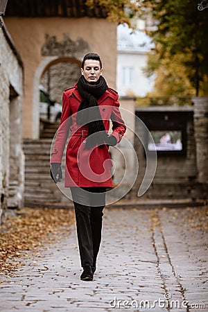 LGBTQ community lifestyle concept. Young homosexual man walks down a street. Handsome fashionable gay male model poses Stock Photo