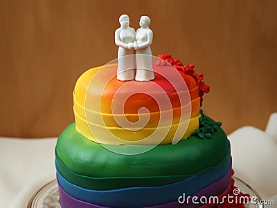 LGBTQ rainbow wedding cake with two woman on top. Lesbian couple wedding cake Stock Photo