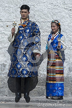 Unidentified Tibetan couple in front of Jokhang temple. The Buddhist Temple in Barkhor Square , Lhasa Tibet Editorial Stock Photo