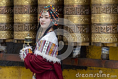 Lhasa, Tibet, China, Chengguan District, June 27 2019: closeup of beautiful young make up girl wearing traditional Tibetan clothes Editorial Stock Photo