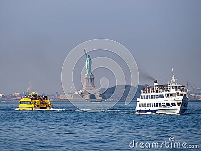 Liberty island, New York City - Statue of Liberty on Hudson river during cruise sunset at dusk Editorial Stock Photo
