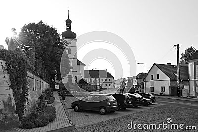 Libesice, Czech republic - May 19, 2018: parked cars between historical houses on little square with Kostel Nanebevzeti Panny Mari Editorial Stock Photo