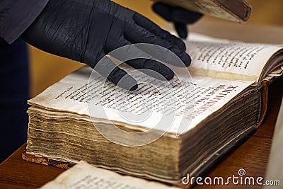 Librarian in gloves holds a rare book Stock Photo