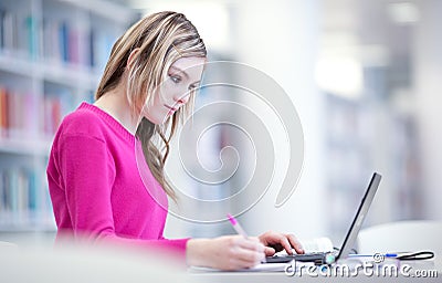 In the library - pretty female student Stock Photo