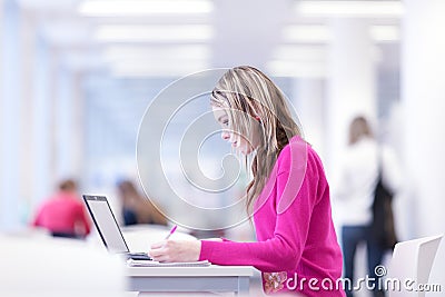 In the library - pretty female student Stock Photo