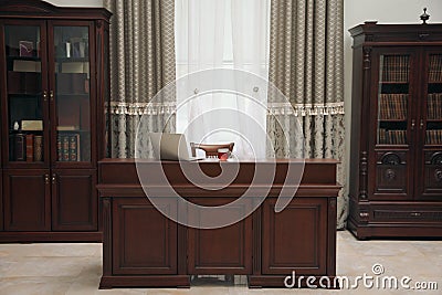 Library reading room interior with wooden bookcases and laptop on table Stock Photo