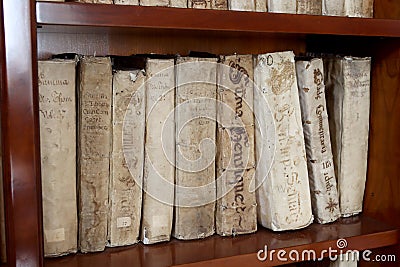 Library shelves with ancient religious books from the 1500s Editorial Stock Photo