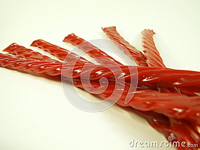Red Licorice Ropes Fanned Out Isolated on White Stock Photo
