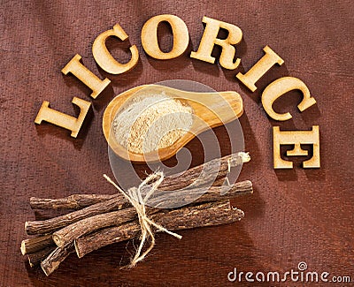 Licorice powder on the wooden table - Glycyrrhiza glabra Stock Photo