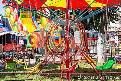 LIDA, BELARUS - JULY 10, 2021: Bright colorful children carousel in the amusement park in summer. Editorial Stock Photo