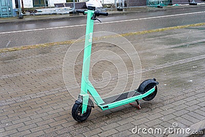 Liepaja, Latvia - 04.01.2023: Parked Bolt green electric scooter on sidewalk Editorial Stock Photo