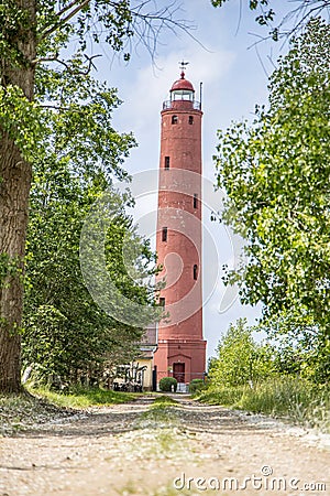 Liepaja, Latvia- July 5, 2023: Akmenraga Beacon lighthouse on a shore of Baltic sea. Road leading to lighthouse Editorial Stock Photo