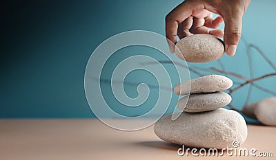 Life Balance Concept. Hand Setting White Natural Zen Stone Stack. Balancing Mind, Soul and Spirit. Mental Meditation Stock Photo