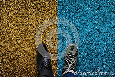 Life Balance Concept for Work and Travel present in top view position by half of Business Oxford and Adventure shoes, Cement Stock Photo
