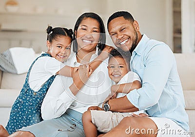Life begins with family and ends with family. a young family happily bonding together on the sofa at home. Stock Photo