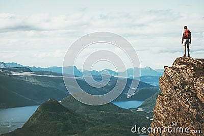 Life on the edge Traveler on cliff mountains Stock Photo