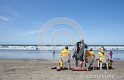 Life guards watch swimmers safety. Editorial Stock Photo