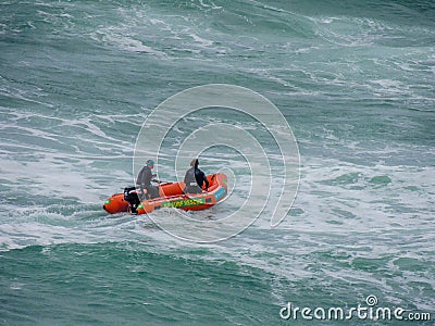 Life guards in a zodiac on wavy ocean Editorial Stock Photo