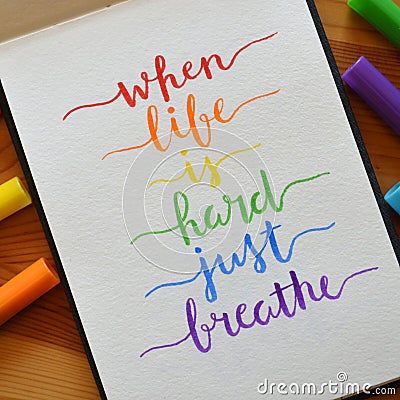 WHEN LIFE IS HARD JUST BREATHE hand-lettered in notebook Stock Photo