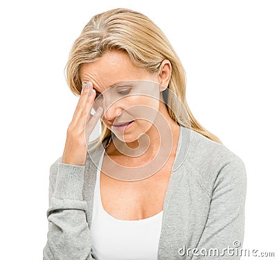 Life has its ups and downs. a mature woman clutching her head in pain against a studio background. Stock Photo