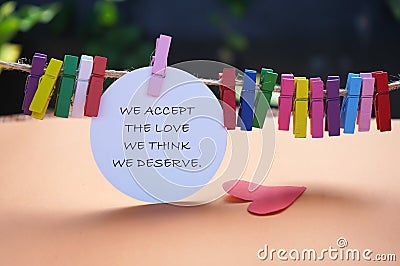 Life inspirational and motivational quote - We accept the love we think we deserve. On colorful background. Stock Photo