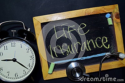 Life Insurance handwriting on chalkboard on top view. Stock Photo