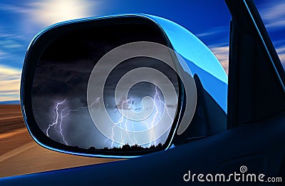 Life is a journey Concept. Difficulties are back. rear view mirror car showing wheater storm backward and sun forward Stock Photo