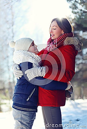 Life portrait of happy family, son hugs his mother in winter Stock Photo