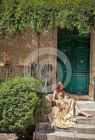 Life in Provence. Woman sitting on the porch and stroking a cat Stock Photo