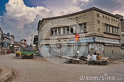 Unemployed people spend time discussing politics and issues in their community. Pakistan Editorial Stock Photo