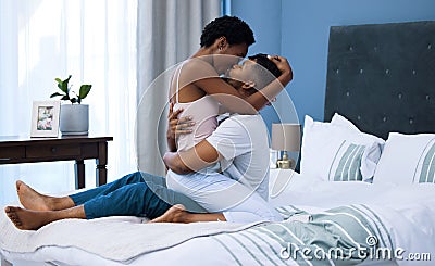 Life rule number one Love one another. a young couple being intimate in bed at home. Stock Photo