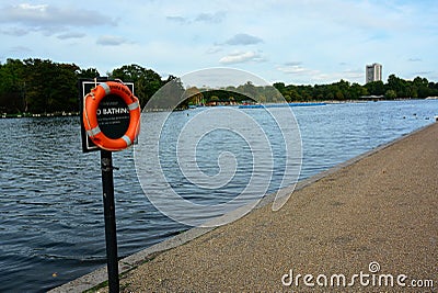 Life saving buoyancy ring at boating lake. Warning sign Editorial Stock Photo